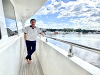 a man standing on the deck of a boat